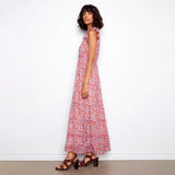 Woman wearing a red floral dress against a white background