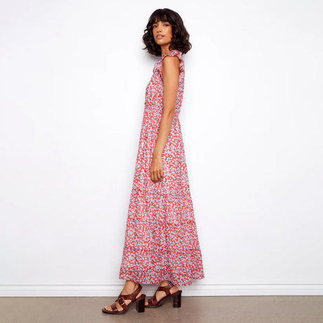 Woman wearing a red floral dress against a white background