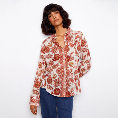 Woman wearing a floral patterned shirt on a white background
