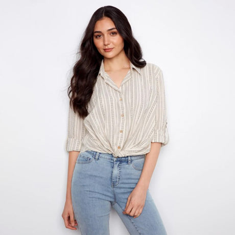 Woman wearing a striped shirt and jeans on a white background
