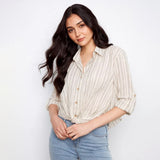 Woman wearing a striped shirt and jeans against a white background
