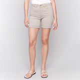 Beige shorts worn by a person on a plain background