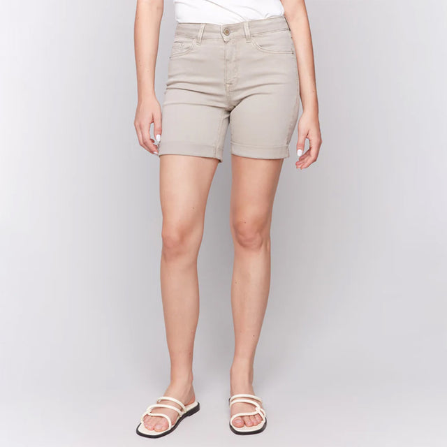Beige shorts worn by a person on a plain background