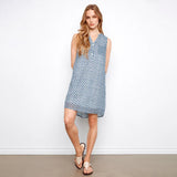 Woman wearing a blue patterned dress against a white background