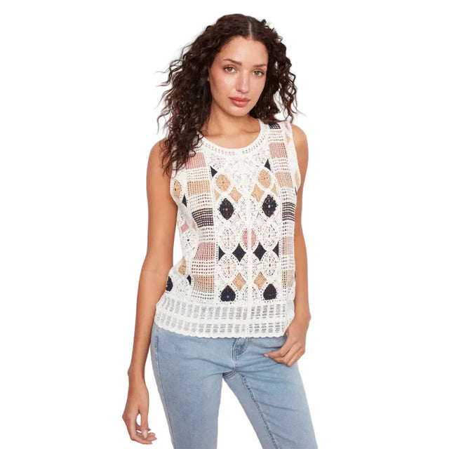 Woman wearing a sleeveless crochet top with geometric pattern on a white background