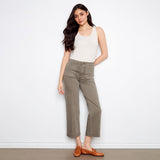 Woman wearing a white tank top and green pants against a white background