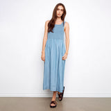 Woman wearing a blue dress against a white background