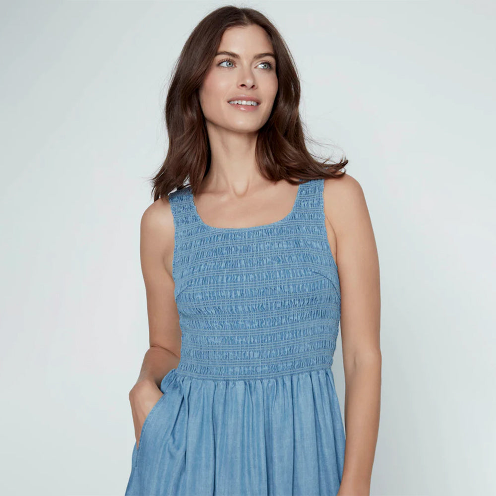 Woman wearing a blue dress against a plain background