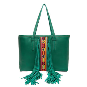 Green handbag with colorful strap and fringes on a white background