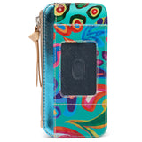 A zip-around wallet with a vibrant multicolor abstract pattern in turquoise, red, green, yellow, and purple, featuring a dark textured ID window and a beige leather zipper pull on a white background.