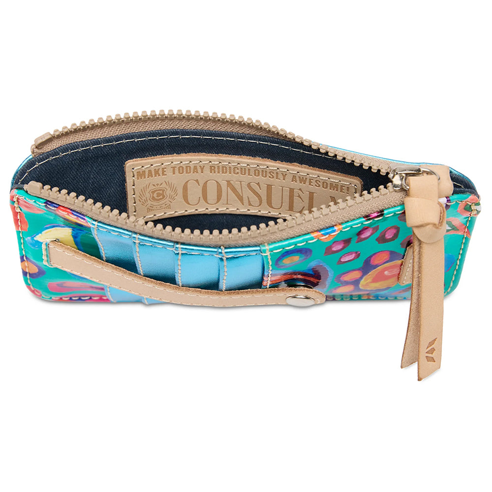 A small zip pouch with a colorful abstract pattern in blue, pink, orange, and green, featuring tan leather trim, a zipper pull, and an interior label that reads 'CONSUE'.
