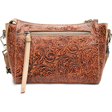Brown leather handbag with intricate patterns on a white background