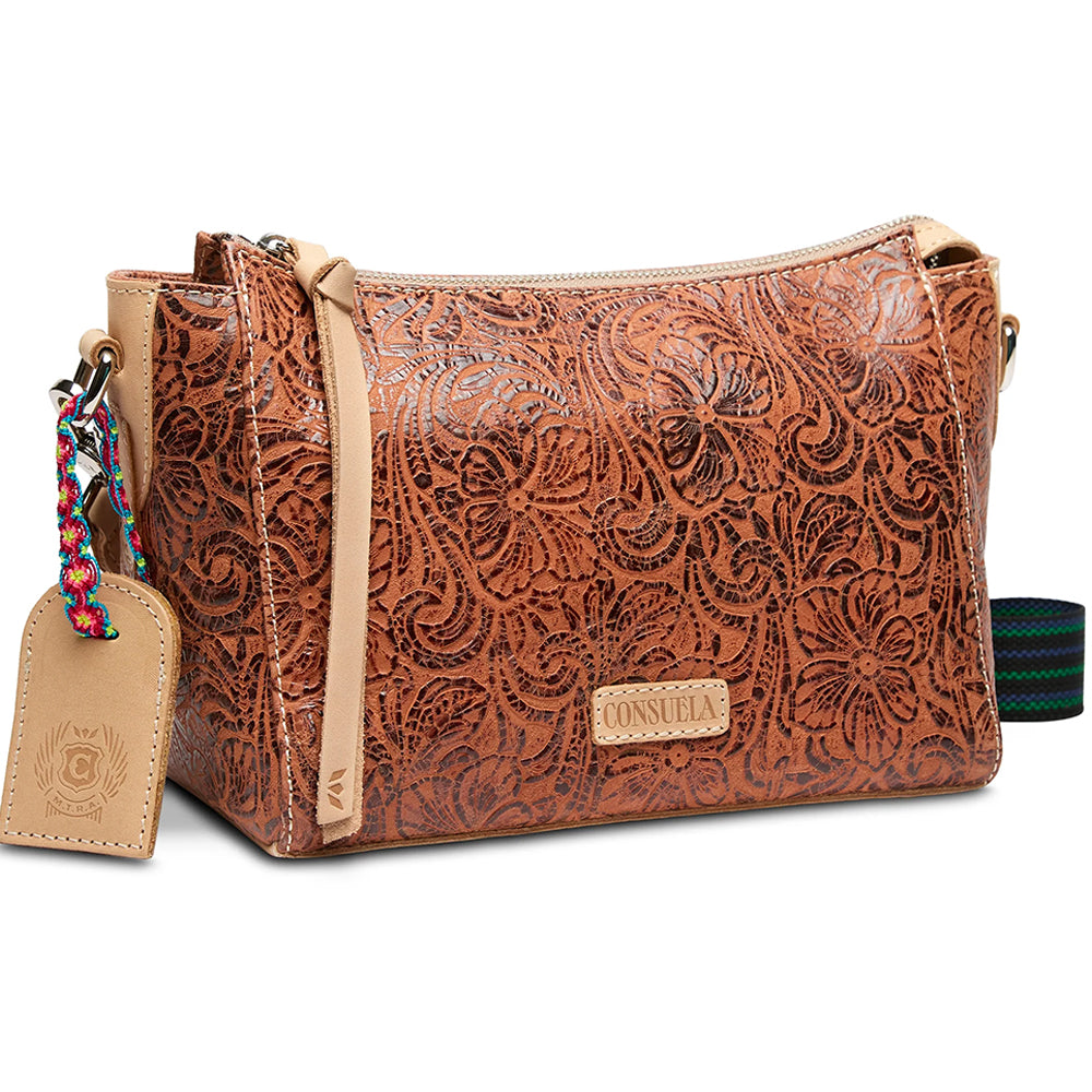 Brown leather handbag with floral patterns and a visible brand tag on a white background