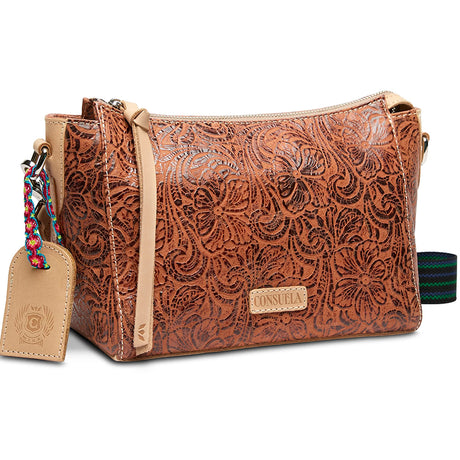 Brown leather handbag with floral patterns and a visible brand tag on a white background