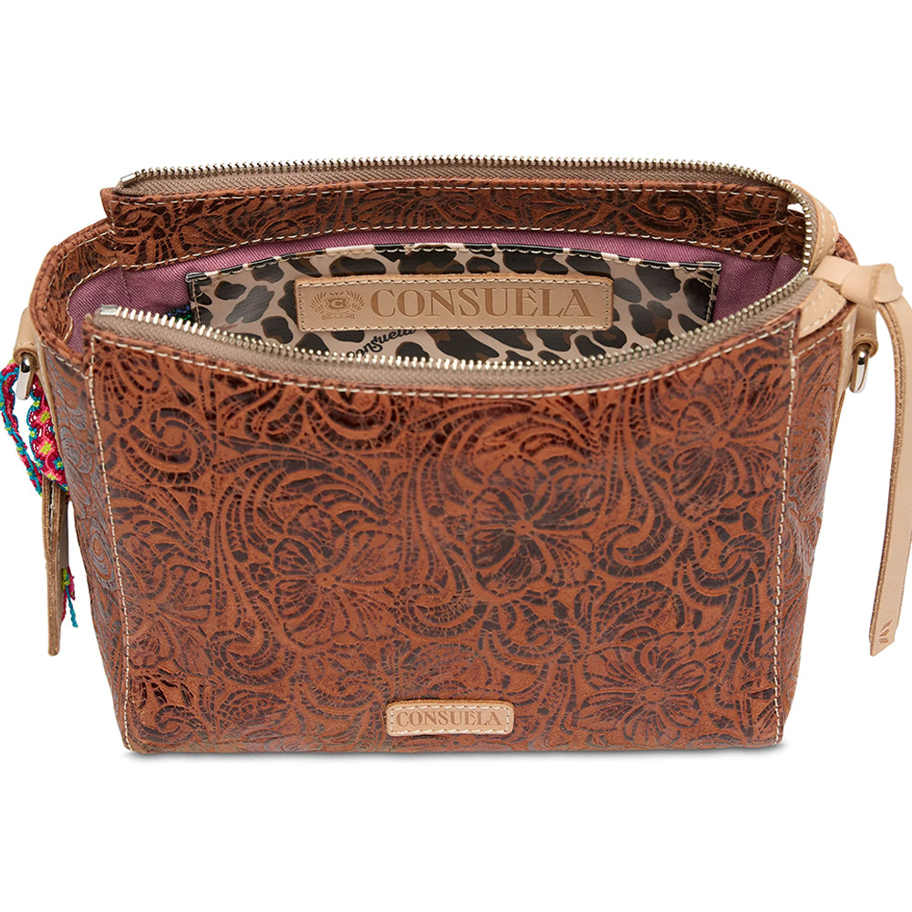 Brown leather bag with intricate patterns and visible Consuela branding on a white background