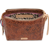 Brown leather bag with intricate patterns and visible Consuela branding on a white background
