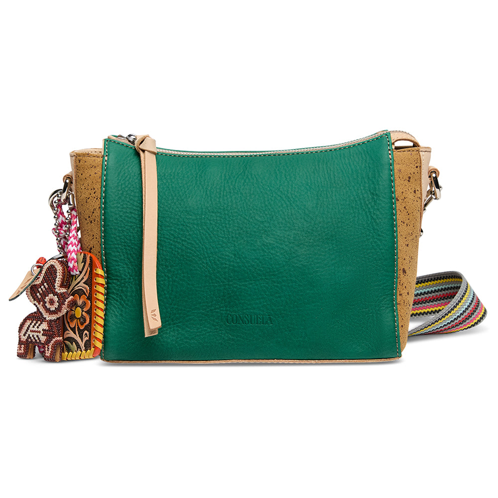 Green leather crossbody bag with cork accents and decorative charm on a white background