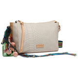 Beige handbag with colorful tassels on a white background
