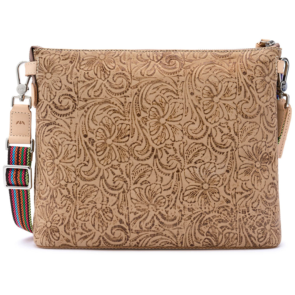 A tan embossed leather pouch with a floral paisley pattern, shown open to reveal a navy blue starry interior lining and a brand label reading 'CONSUELA'.