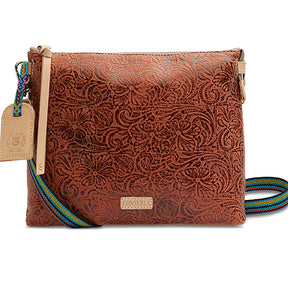 Brown leather crossbody bag with intricate pattern and colorful strap on a white background