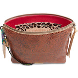 Brown patterned handbag with a leopard print pouch inside on a white background
