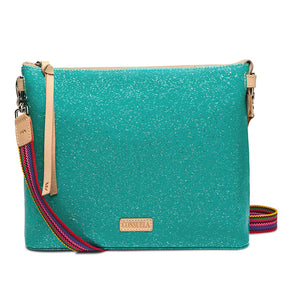 A turquoise glitter purse with a gold zipper and a tan leather brand patch inside, shown open on a white background.