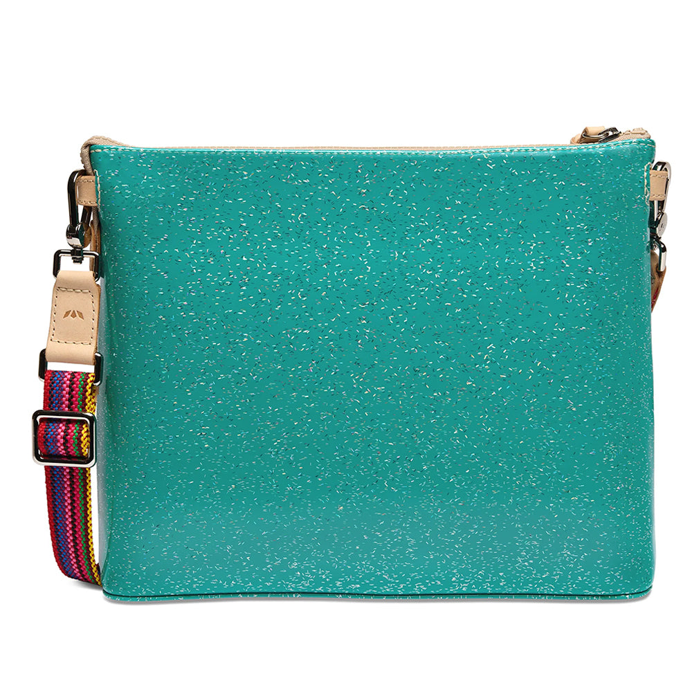 A turquoise glittery crossbody bag with a colorful woven strap and beige leather accents, shown against a plain white background.