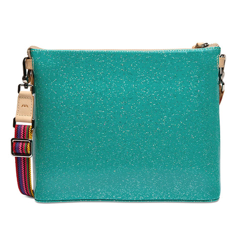A turquoise glittery crossbody bag with a colorful woven strap and beige leather accents, shown against a plain white background.