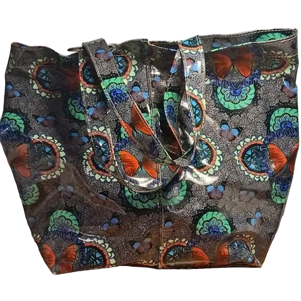 Colorful butterfly-patterned bag on a wooden surface with a white background