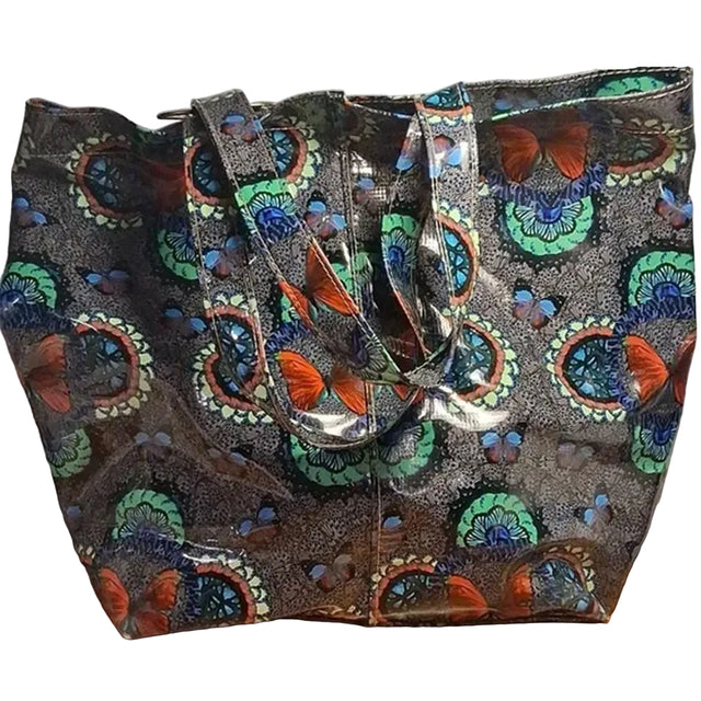 Colorful butterfly-patterned bag on a wooden surface with a white background