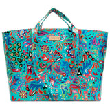 A large tote bag with a vibrant, multicolored psychedelic paisley pattern on a turquoise background, featuring dual top handles and a small metallic brand plaque.