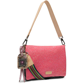 A pink glitter crossbody bag with a bright pink glitter trim along the top, a beige shoulder strap, and a front zippered pocket with a beige pull tab.