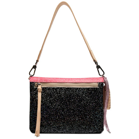 A black glitter crossbody bag with a bright pink glitter trim along the top, a beige shoulder strap, and a front zippered pocket with a beige pull tab.