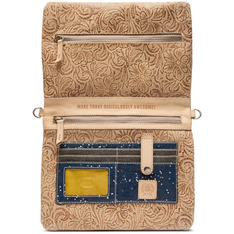 A tan tooled leather wallet with floral embossed patterns, featuring multiple zippered compartments, a card slot with a blue denim insert, and a yellow ID window.
