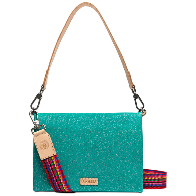 A turquoise glitter shoulder bag with a tan leather strap and a colorful striped woven shoulder strap, shown on a white background.