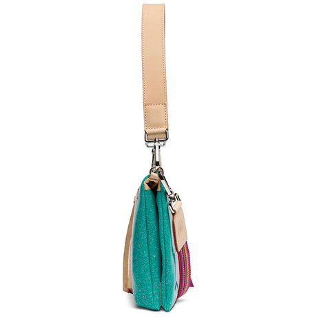 A side profile view of a handbag with a turquoise glittery body, beige leather strap and trim, and a pink and blue patterned accent panel, shown on a white background.