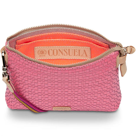 Pink woven handbag with orange interior and 'Consuela' branding on a white background
