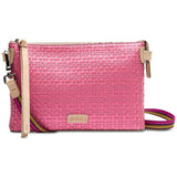 Pink woven handbag with a strap on a white background