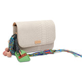 Beige handbag with colorful strap and decorative elements on a white background