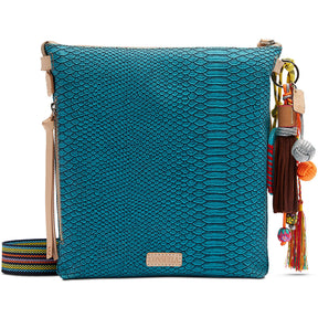 Blue textured handbag with colorful tassels on a white background