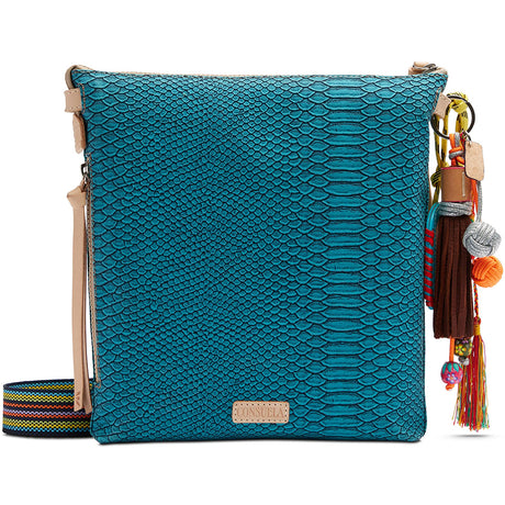 Blue textured handbag with colorful tassels on a white background