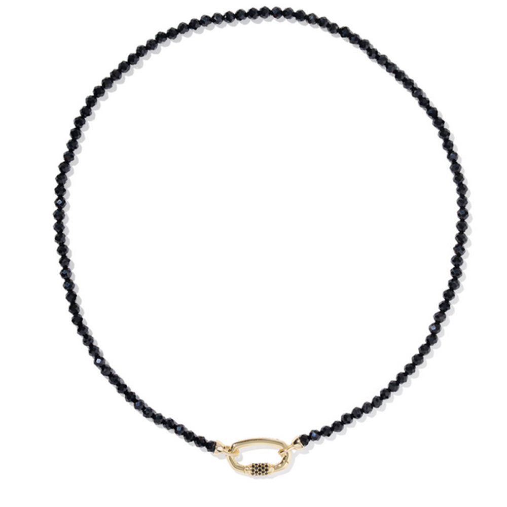Black beaded necklace with a gold clasp on a white background