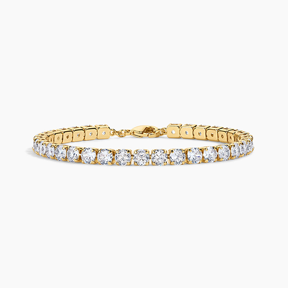 A yellow gold tennis bracelet featuring a continuous row of round-cut clear gemstones, displayed on a clean white background.