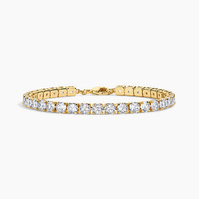 A yellow gold tennis bracelet featuring a continuous row of round-cut clear gemstones, displayed on a clean white background.