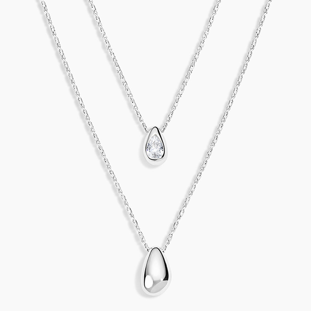 Two silver teardrop pendant necklaces on delicate chains, displayed against a clean white background.
