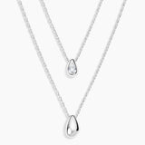 Two silver teardrop pendant necklaces on delicate chains, displayed against a clean white background.