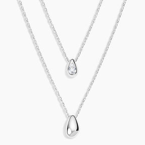 Two silver teardrop pendant necklaces on delicate chains, displayed against a clean white background.