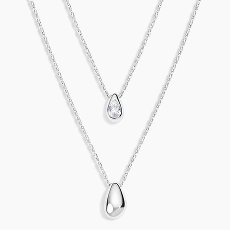 Two silver teardrop pendant necklaces on delicate chains, displayed against a clean white background.