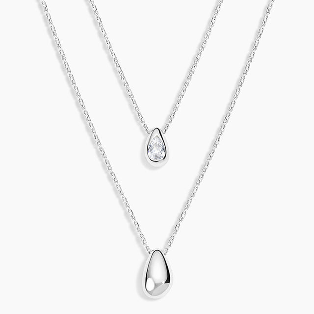 Two silver teardrop pendant necklaces on delicate chains, displayed against a clean white background.