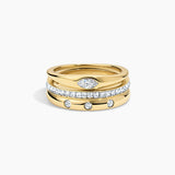 A stack of three gold rings on a light gray background. The top ring is plain gold, the middle ring is paved with clear stones, and the bottom ring is gold with three small clear stones spaced along it.
